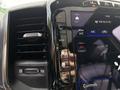 Close-up view of the control panel in a 2021 RAM 1500 featuring air conditioning settings and digital display controls
