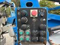 Control panel of a 2016 Genie TZ-34/20 featuring various buttons and switches for operation including a large red stop button and directional controls