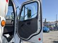 A 2014 Freightliner M2 106 truck with an open driver's door showcasing the interior handle and panel details