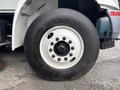 A close-up of a tire on a 2012 International DuraStar 4300 showing the tread and wheel rim with multiple bolt holes
