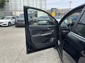 A 2014 Honda CR-V with the driver's side door open showcasing the interior features and control panel