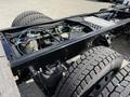 Close-up view of the chassis of a 2022 Lion Lion6 electric vehicle showing the tires suspension system and wiring connections