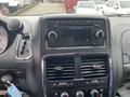 Dashboard of a 2014 RAM Cargo Van featuring a radio display and control knobs with a gear shifter adjacent to it