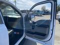 A 2018 Ford F-150 with the driver's side door open showcasing the interior details and dashboard