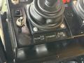 Control panel with joystick levers and labeled buttons for plow operation including "PLow," "Standby," and directional controls for left and right plowing