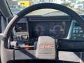 Dashboard of a 1996 GMC Top Kick showing speedometer and gauges with a GMC-branded steering wheel in the foreground