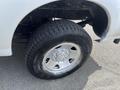 Close-up of a black tire and silver rim from a 2014 Ford F-250 SD with visible tread pattern and wheel well