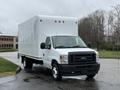 A 2024 Ford E-450 box truck with a white cargo area and a black front grille parked at an angle