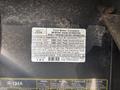 2012 Ford E-450 engine compartment label detailing emissions control information and fuel specifications