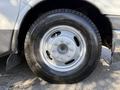 The close-up view of a silver wheel on a 2017 Chevrolet Express showcasing a tire labeled Agilis CrossClimate and featuring a multi-stud design