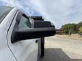 A close-up of the side mirror of a 2016 RAM 5500 truck showing droplets of water on its surface