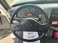 Black steering wheel of a 2012 International 7300 Workstar with various gauges and controls visible on the dashboard