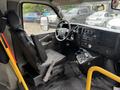 Interior of a 2018 Chevrolet Express showing the driver's seat dashboard and controls with a focus on the steering wheel and gear shift