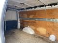 2023 GMC Savana cargo van interior featuring plywood walls and a bare wooden floor with space for storage and transportation purposes