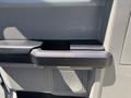 A close-up view of the interior door handle of a 2019 Ford F-150 featuring a black plastic grip and textured surface