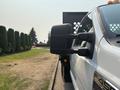 A white 2009 Ford F-450 Super Duty pickup truck is shown from the side with a focus on its side mirror and front grill area