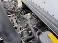 Close-up view of the engine components of a 2018 Hino 195 showing various pipes and sensors