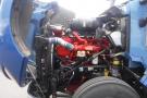 Close-up of a 2015 Kenworth T660 engine showcasing red and silver components including hoses filters and cooling systems