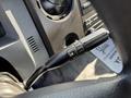Close-up of the control lever in a 2018 Ford F-750 showing a black grip with a plus and minus indicator for adjusting settings