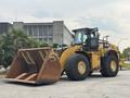 A yellow 2012 Caterpillar 980 wheeled loader with a large bucket in the front designed for lifting and moving heavy materials