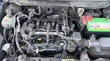 Close-up view of the engine compartment of a 2019 Nissan Kicks showing various engine components and wiring