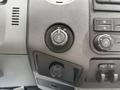 Close-up of the control panel in a 2011 Ford F-250 SD featuring a rotary switch and various buttons for vehicle functions