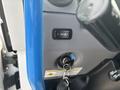 Close-up of the dashboard of a 2020 Lion Lion6 showing a blue handle a button for lights and a key ignition cylinder