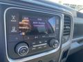 The image shows the dashboard of a 2015 RAM 2500 with a multimedia display screen indicating an AUX device is connected