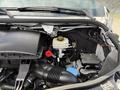 Engine compartment of a 2022 Mercedes-Benz Sprinter featuring a reservoir tank and various mechanical components