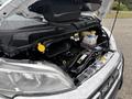 The engine compartment of a 2023 RAM Promaster 3500 featuring a prominently displayed engine and labeled fluid reservoirs