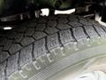 Close-up of a treaded tire from a 2015 Ford F-350 SD showing detailed patterns and grooves designed for traction