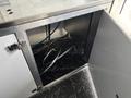 Interior view of a 2020 Freightliner MT45 showing storage space with silver metal framework and black flooring