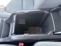 A central console storage compartment of a 2017 Chevrolet Colorado with a dark plastic interior and a rectangular shape