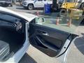 A 2014 Mercedes-Benz CLA-Class with its driver's door open showcasing the interior and door panel design