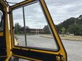 A 2004 Bombardier SW48 viewed from the open door with a clear view of the interior and control panel visible inside the cab