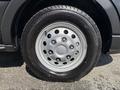Close-up of a silver rim with multiple holes mounted on a black tire from a 2025 Ford Transit T-350