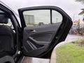 A 2016 Mercedes-Benz GLA-250 with the driver's side door open showcasing the interior handle and upholstery