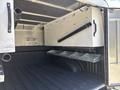 A 2019 Ford F-150 truck bed with a customized storage setup including compartments and hooks along the walls