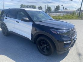 A 2020 Ford Explorer featuring a black and white exterior with distinctive styling and black wheels