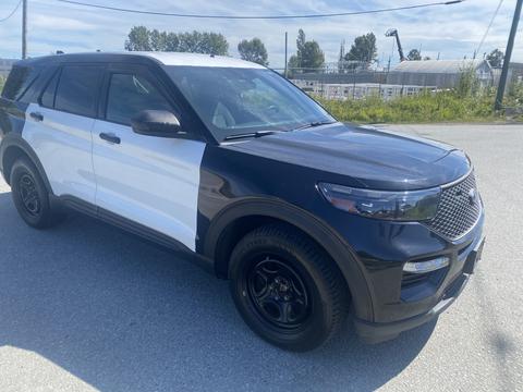 A 2020 Ford Explorer featuring a black and white exterior with distinctive styling and black wheels