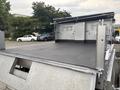 A 2014 Ford F-550 with a flatbed design and a textured bed surface showing hooks for securing cargo