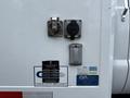 Close-up of the rear side panel of a 2011 Ford F-650 displaying various connectors locks and company stickers