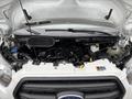 A 2020 Ford Transit 250 with its hood lifted exposing the engine compartment showing various engine components and fluids