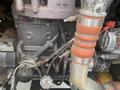 A 2010 Vermeer Corporation BC1000XL engine with visible hoses wires and an alternator assembly