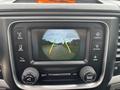 A dashboard display showing a rearview camera view with guidelines for parking in a 2016 RAM 1500