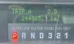 Display panel of a 2009 Ford F-550 showing trip distance of 0.0 and total distance of 244085.1 km with fuel type indicated as ultra low sulfur diesel fuel only