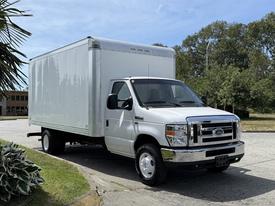 A 2018 Ford E-450 box truck with a white exterior and a large cargo area attached to the rear