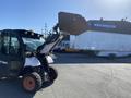A 2015 Bobcat 5600 compact utility vehicle with a raised loader bucket and sleek design