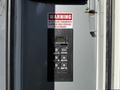 Close-up of a control panel with buttons for gear selection and a warning label for a 2011 Freightliner M2 106 indicating not to reverse while hydraulic PTO is engaged