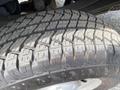 Close-up of a treaded tire from a 2014 Ford F-350 SD showing detailed patterns and grooves designed for traction and performance